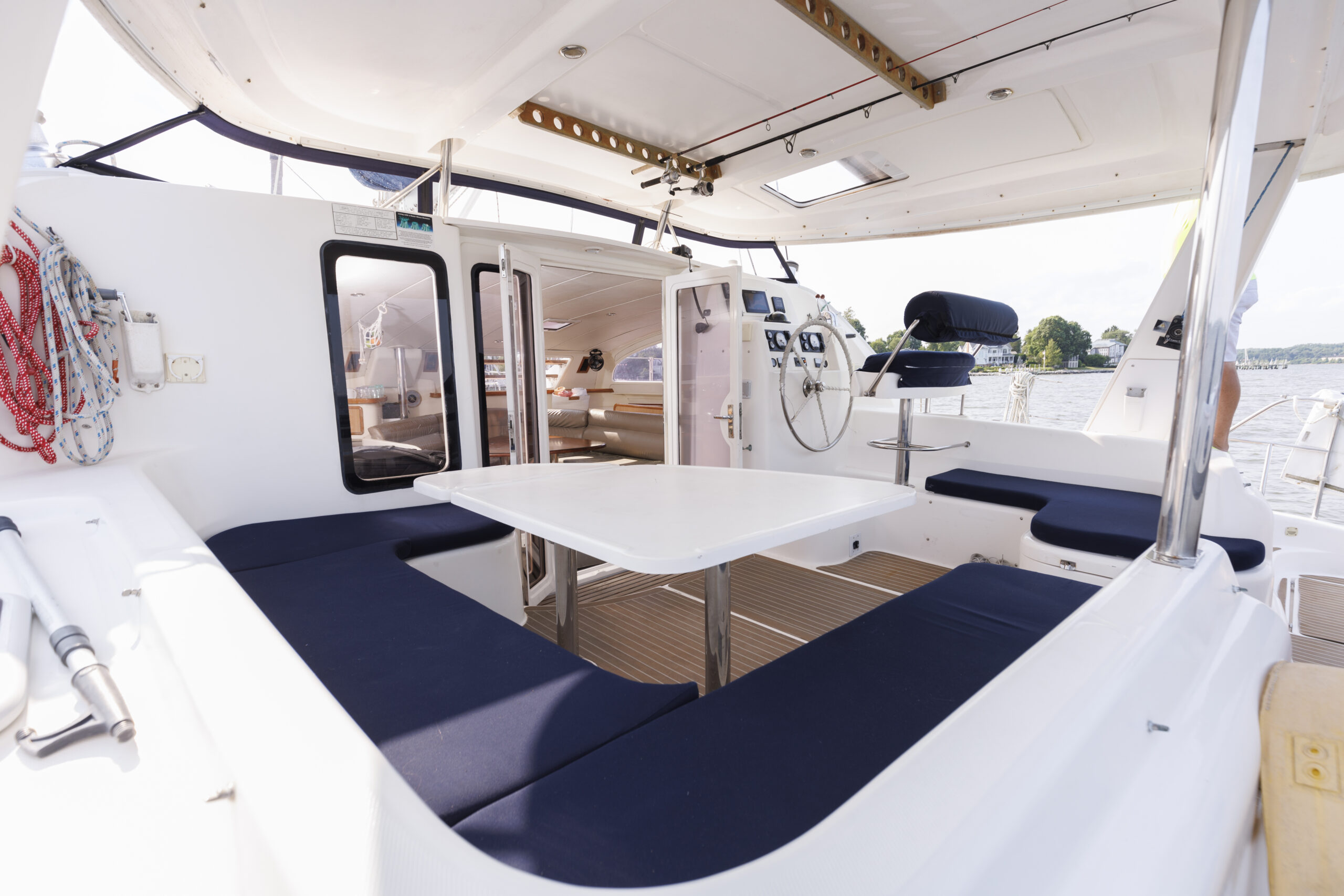 A white table and chairs on top of a boat.