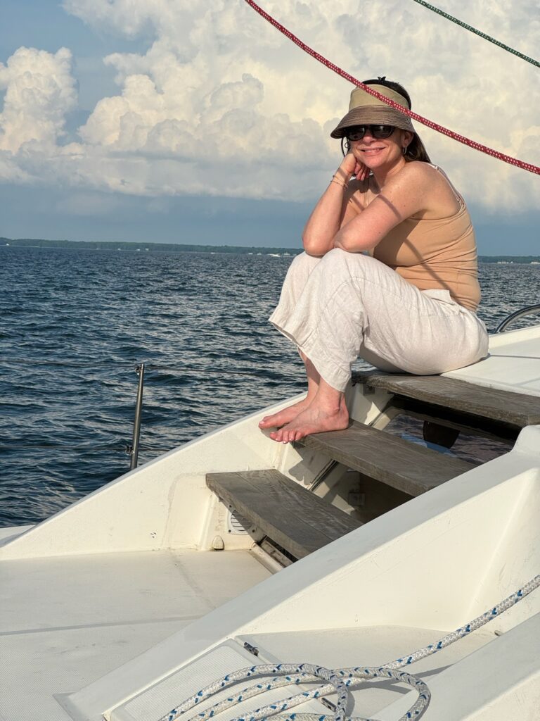 A woman sitting on the front of a boat.