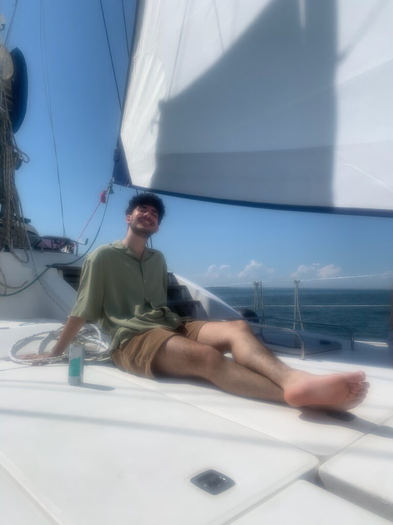 A man sitting on the deck of a boat.