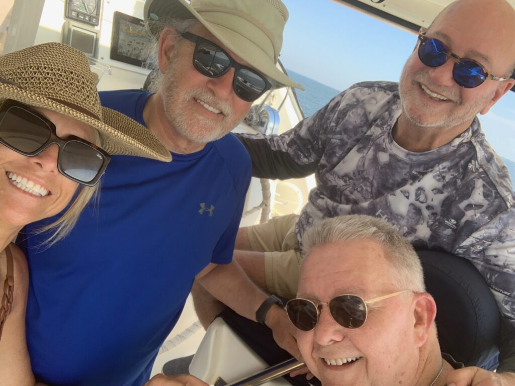 Three people are posing for a picture on the boat.