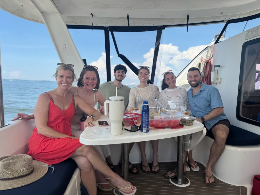 A group of people sitting at the table on a boat.