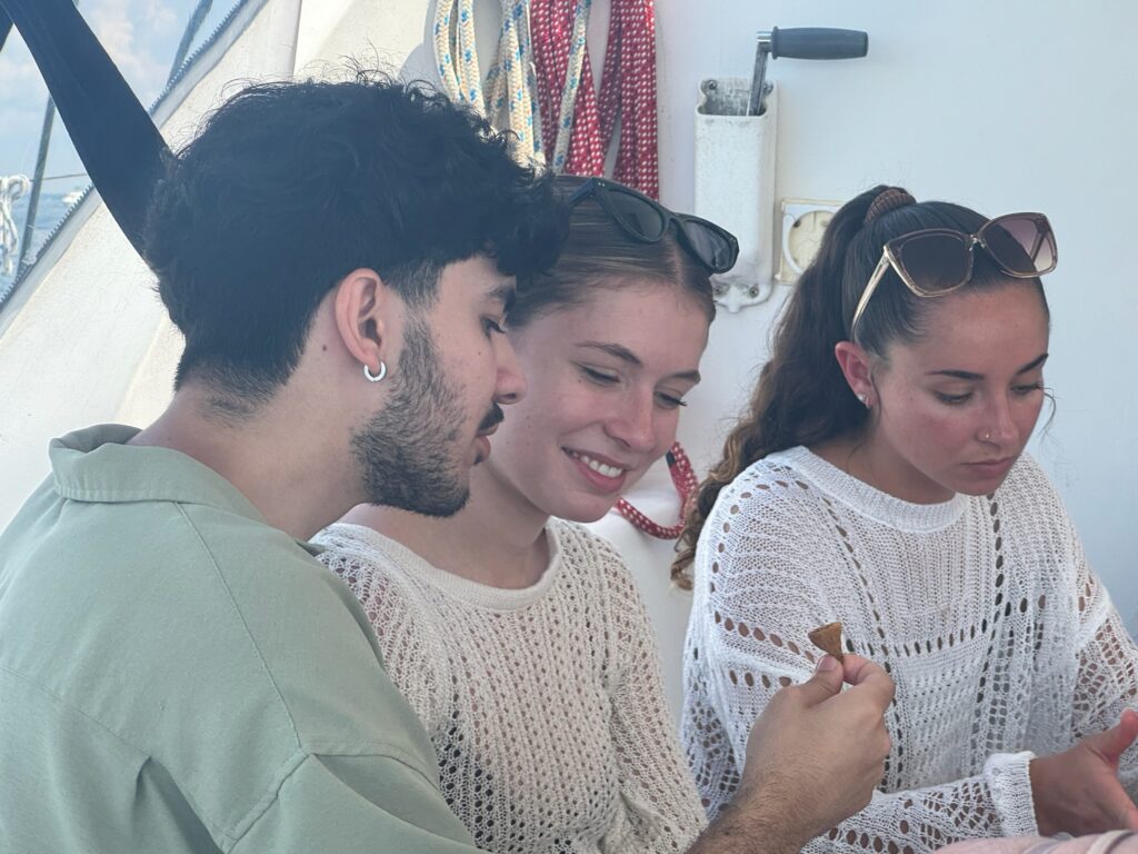A group of people sitting around each other.