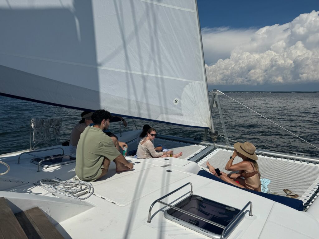 A group of people sitting on the deck of a boat.